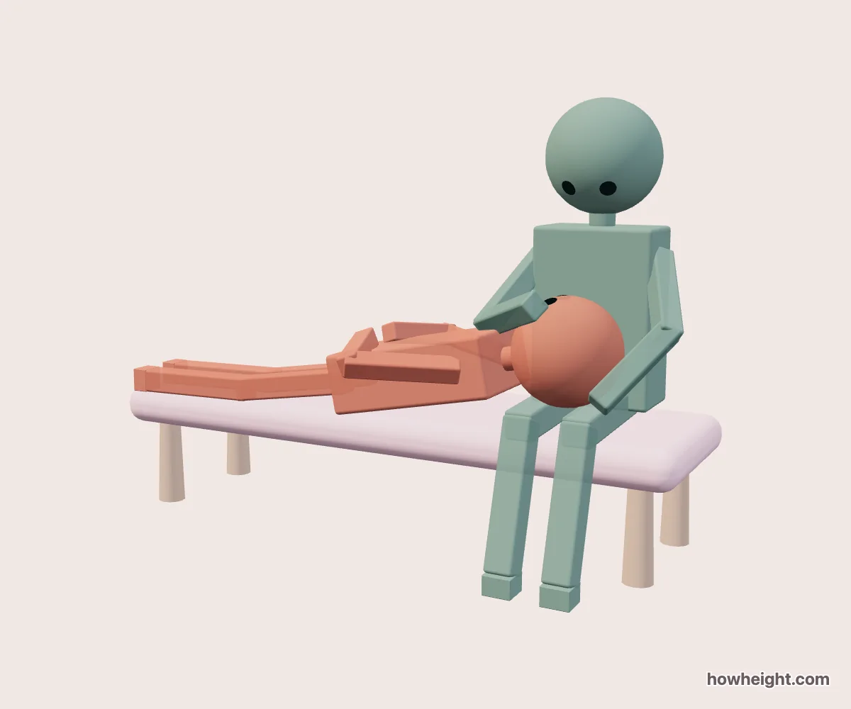 Lap Pillow Simulator: One person lies with their head resting in the seated person’s lap.